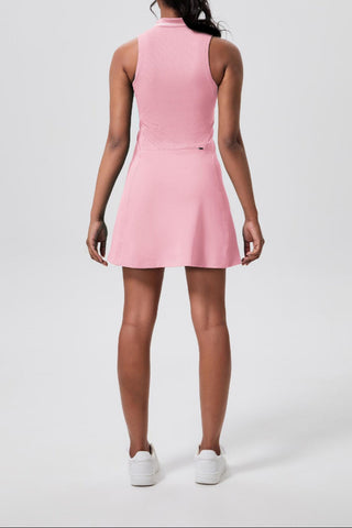 Person wearing a pink dress on a white background